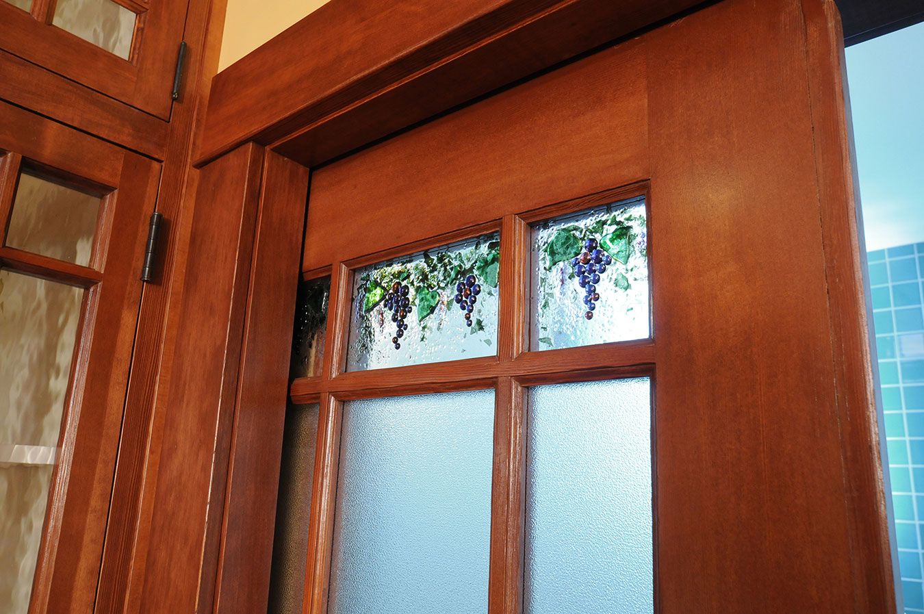 custom solid wood door with stained glass window panes