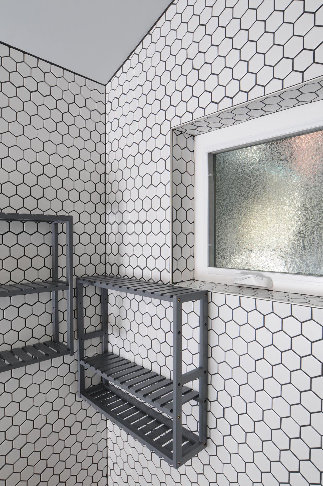 remodeled bathroom tiled walls and shelving