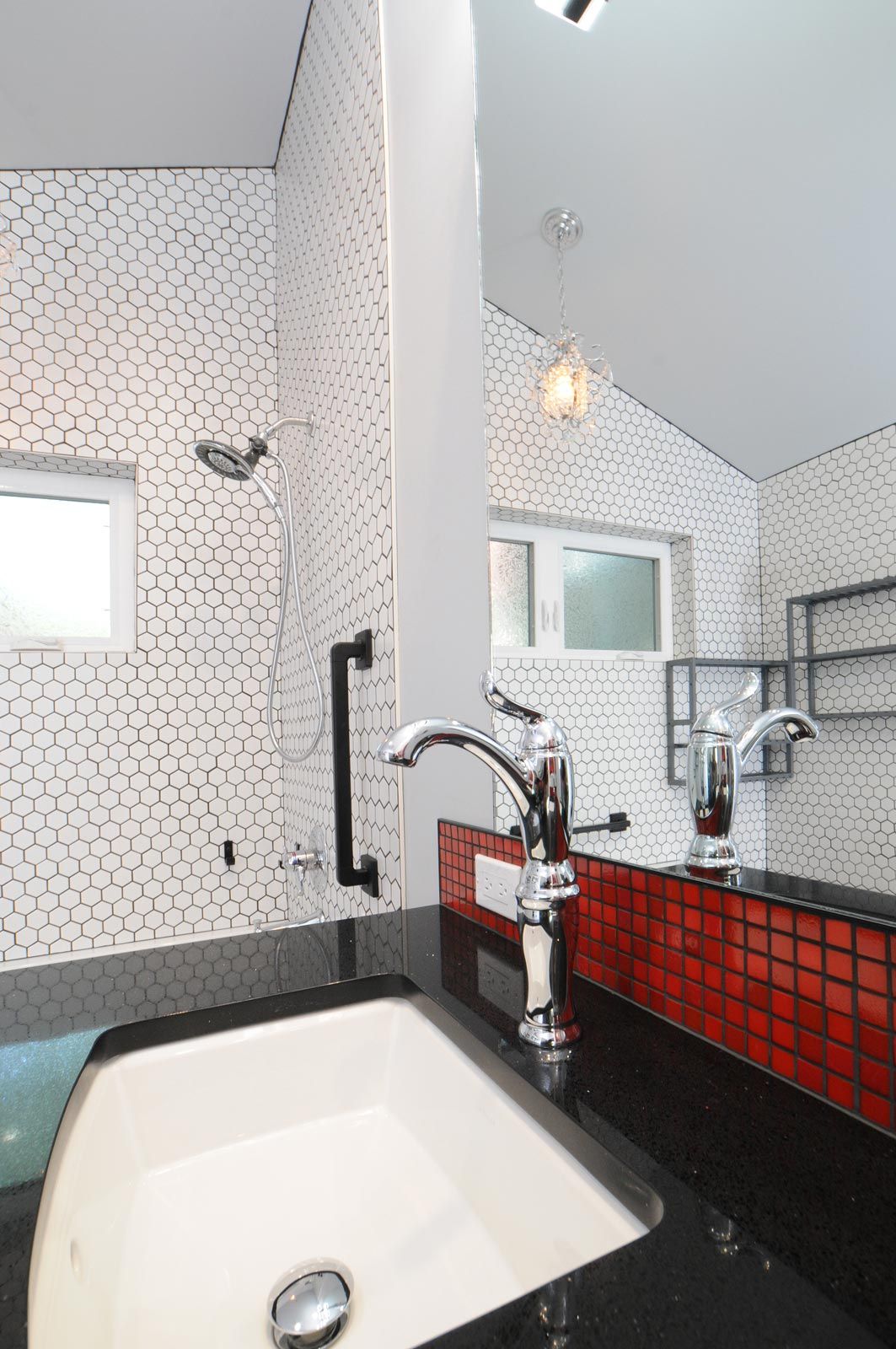 custom tiled shower and sink backsplash