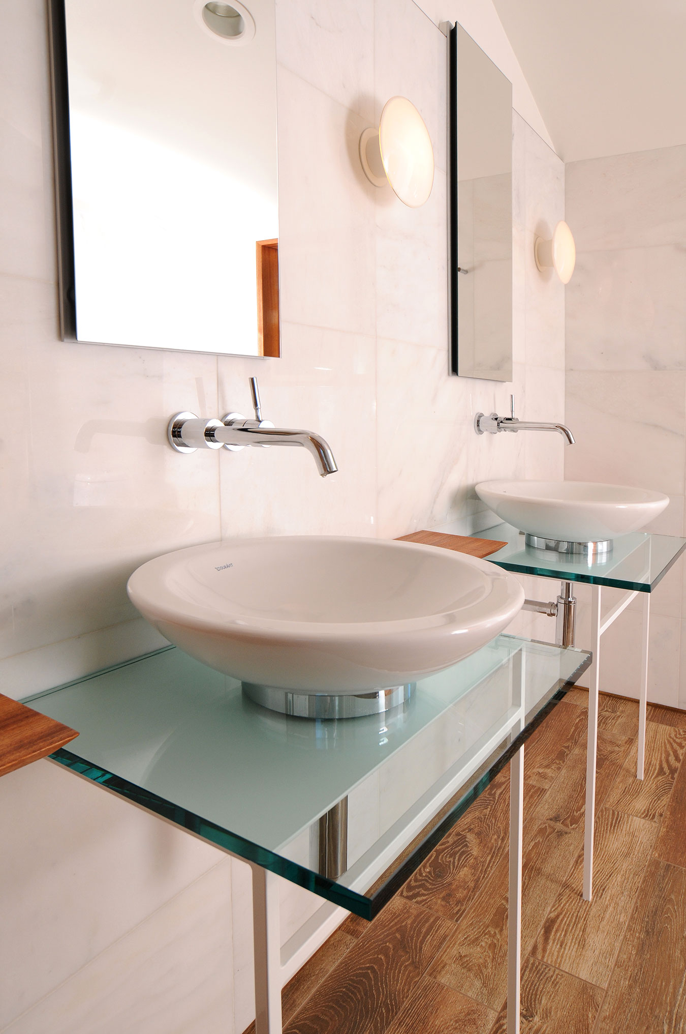custom design modern bathroom with floating sinks, marble tile walls and wood flooring