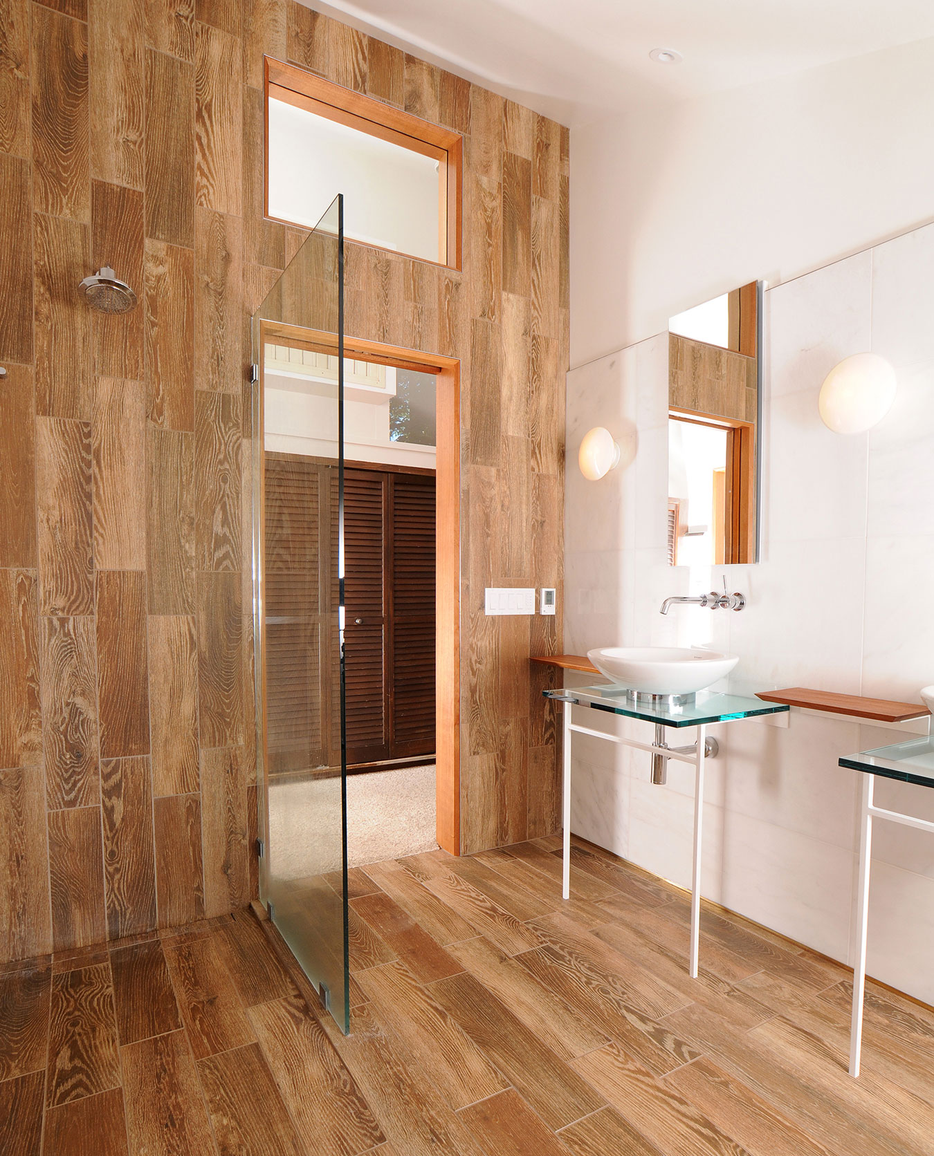 custom wood panel open bathroom design with floating sinks